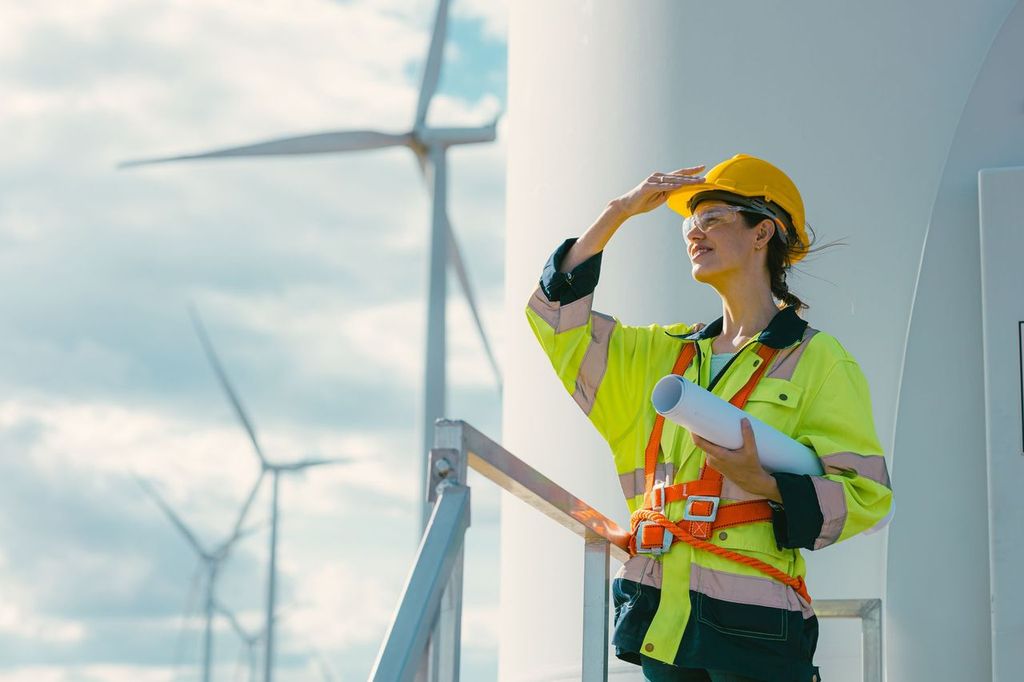 woman in safety gear working on a wind warm